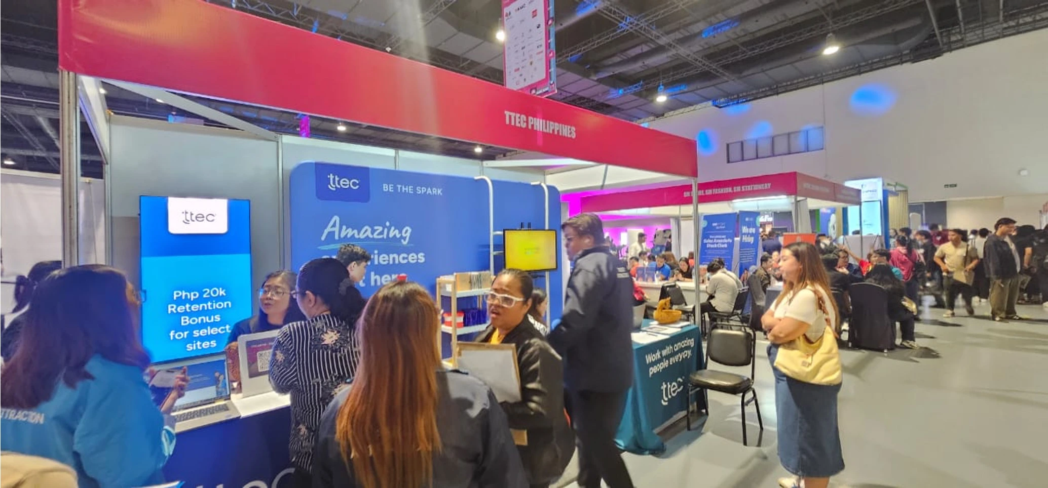 A busy TTEC Philippines recruitment booth at a job fair